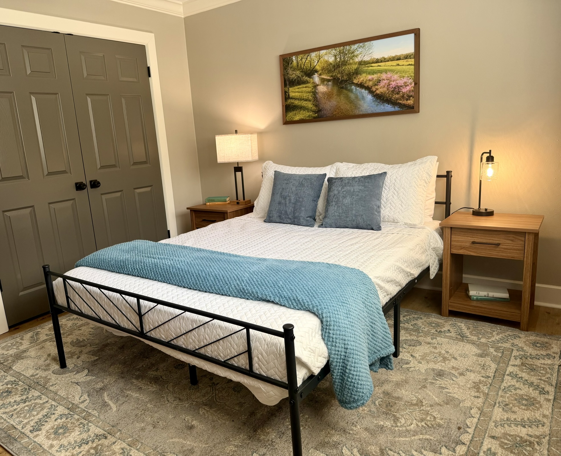 Bedroom two alternate view with blue bedding nightstands and warm lighting
