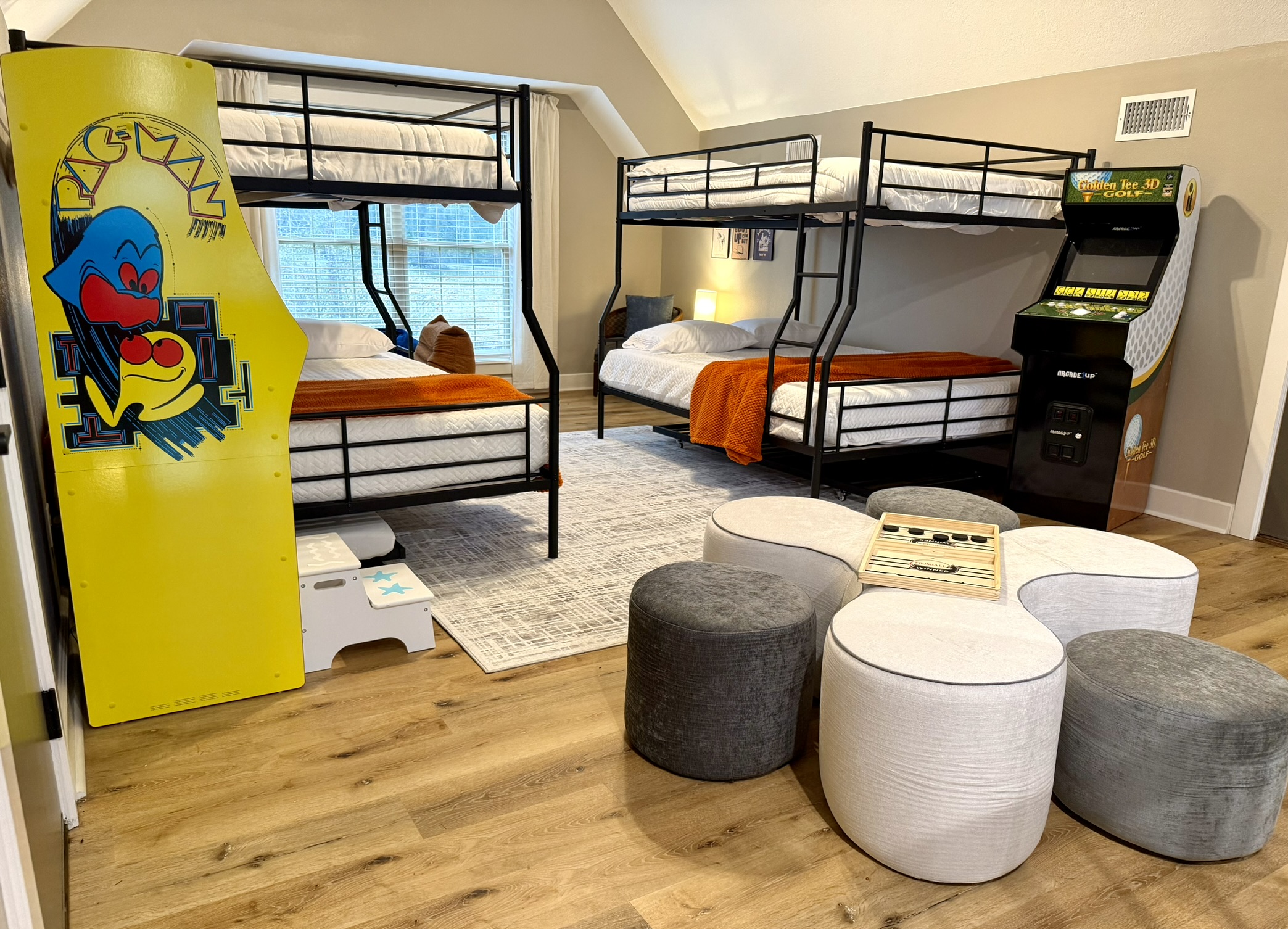 Southern Delight bunk loft with Pac-Man and Golden Tee arcade games and custom bunk beds