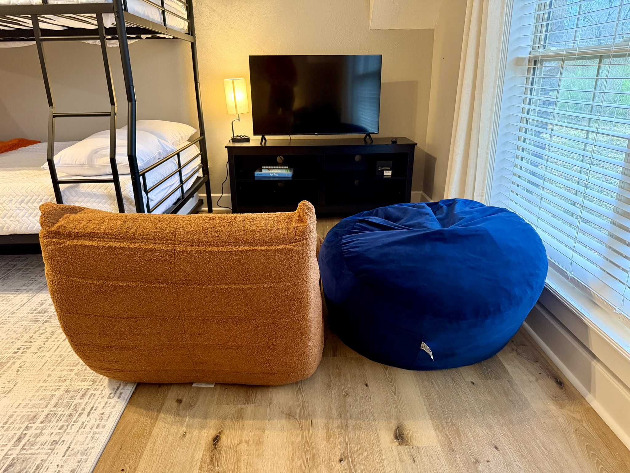 Bunk loft lounge area with bean bag chairs Roku TV and bunk bed