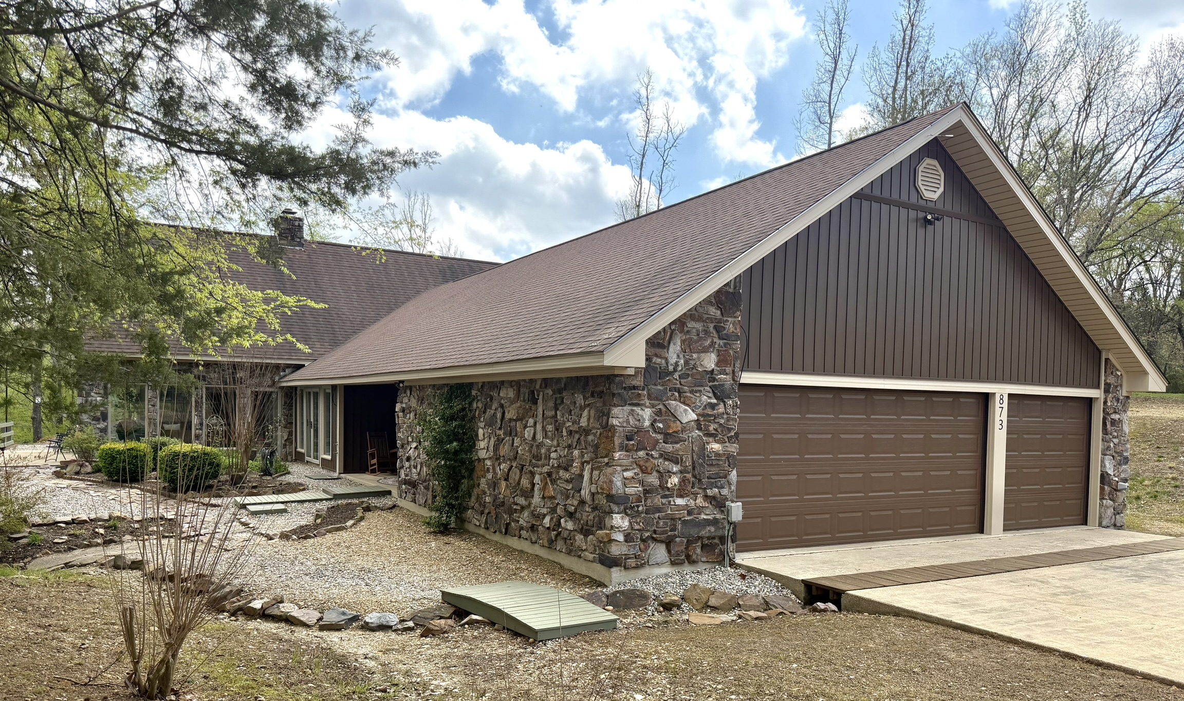 Southern Delight front exterior with stone chimney and A-frame garage in Delight Arkansas