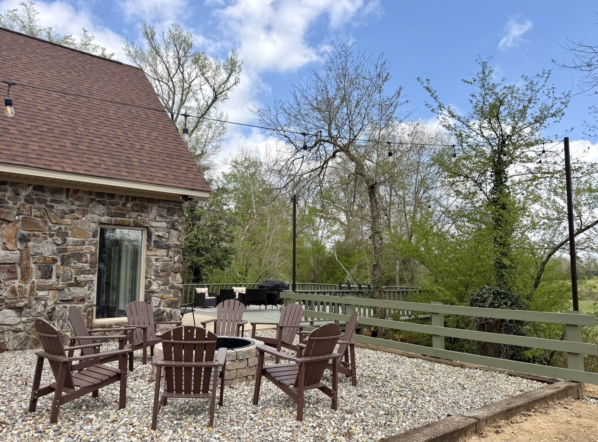 Southern Delight fire pit with Adirondack chairs and string lights