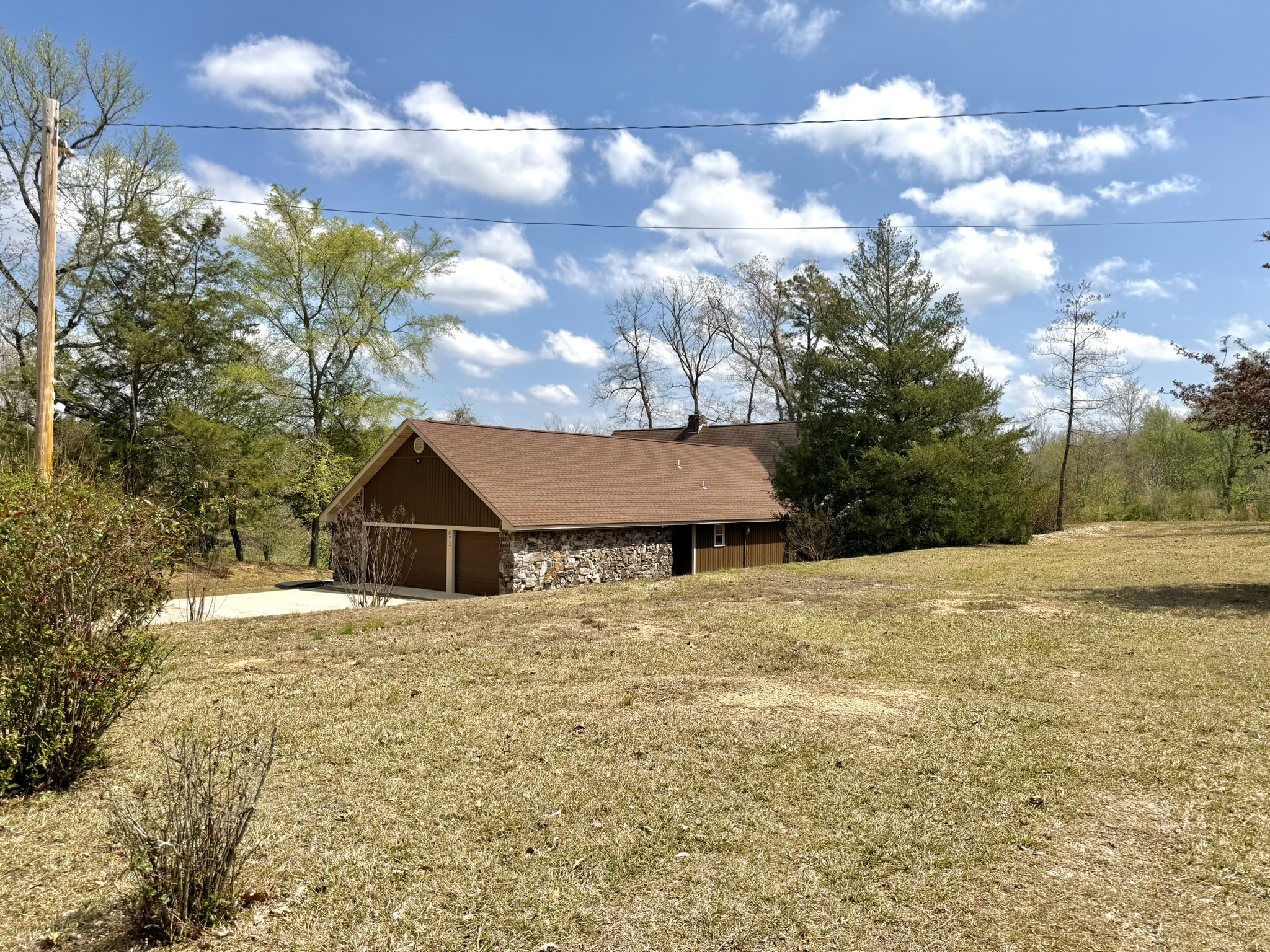 Southern Delight detached garage and stone exterior from the front yard