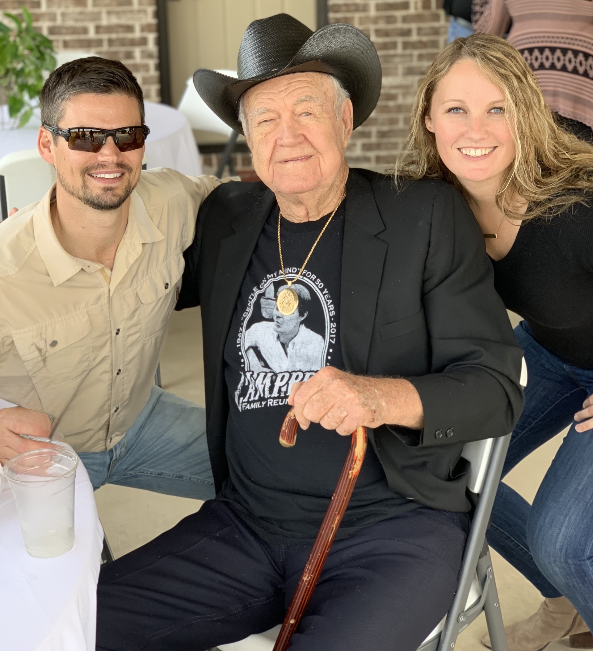 Sean and Ashley with Seans grandfather Punkin wearing a cowboy hat and Glen Campbell memorial shirt